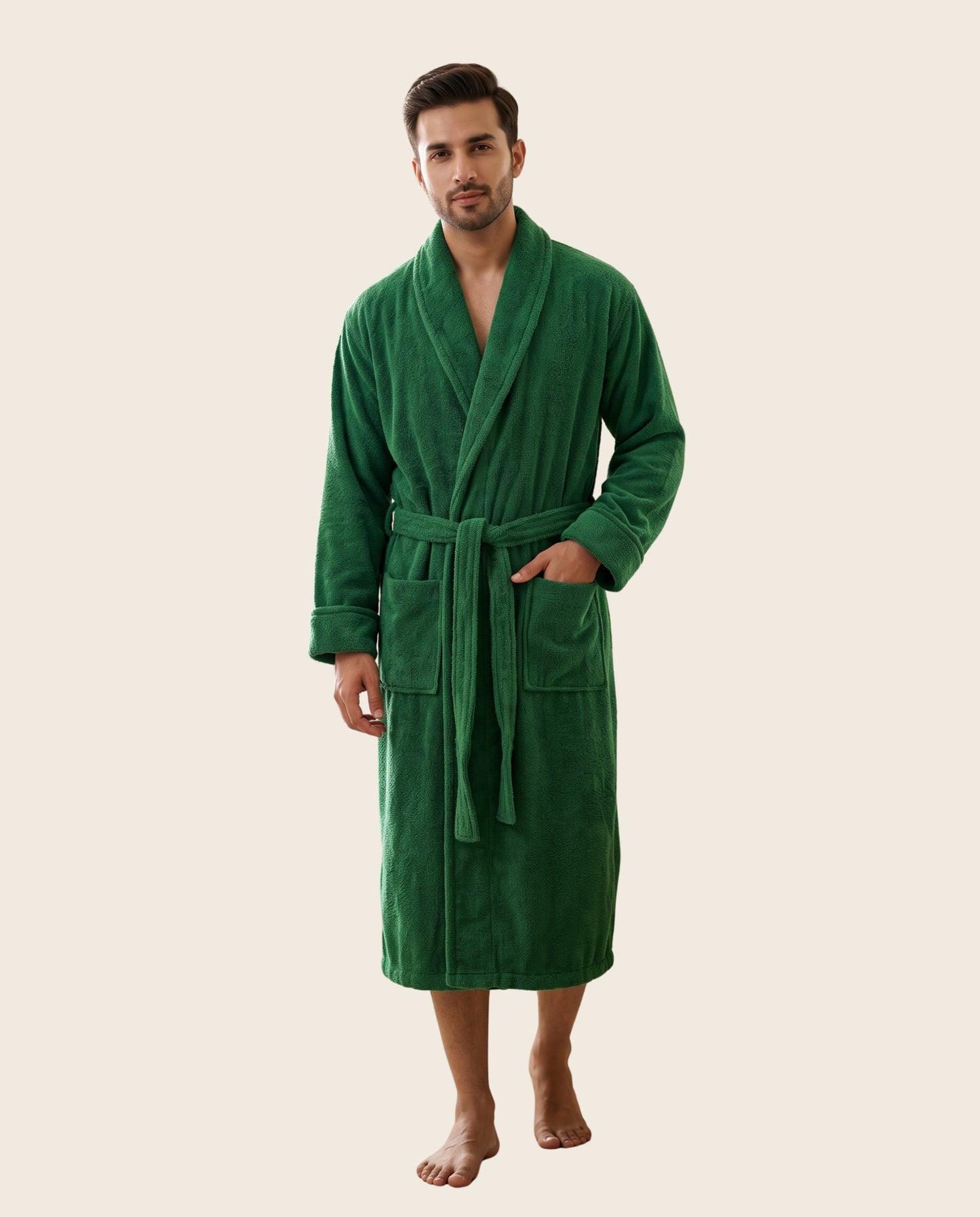 A man wearing a plush green bathrobe, standing against a solid light beige background.