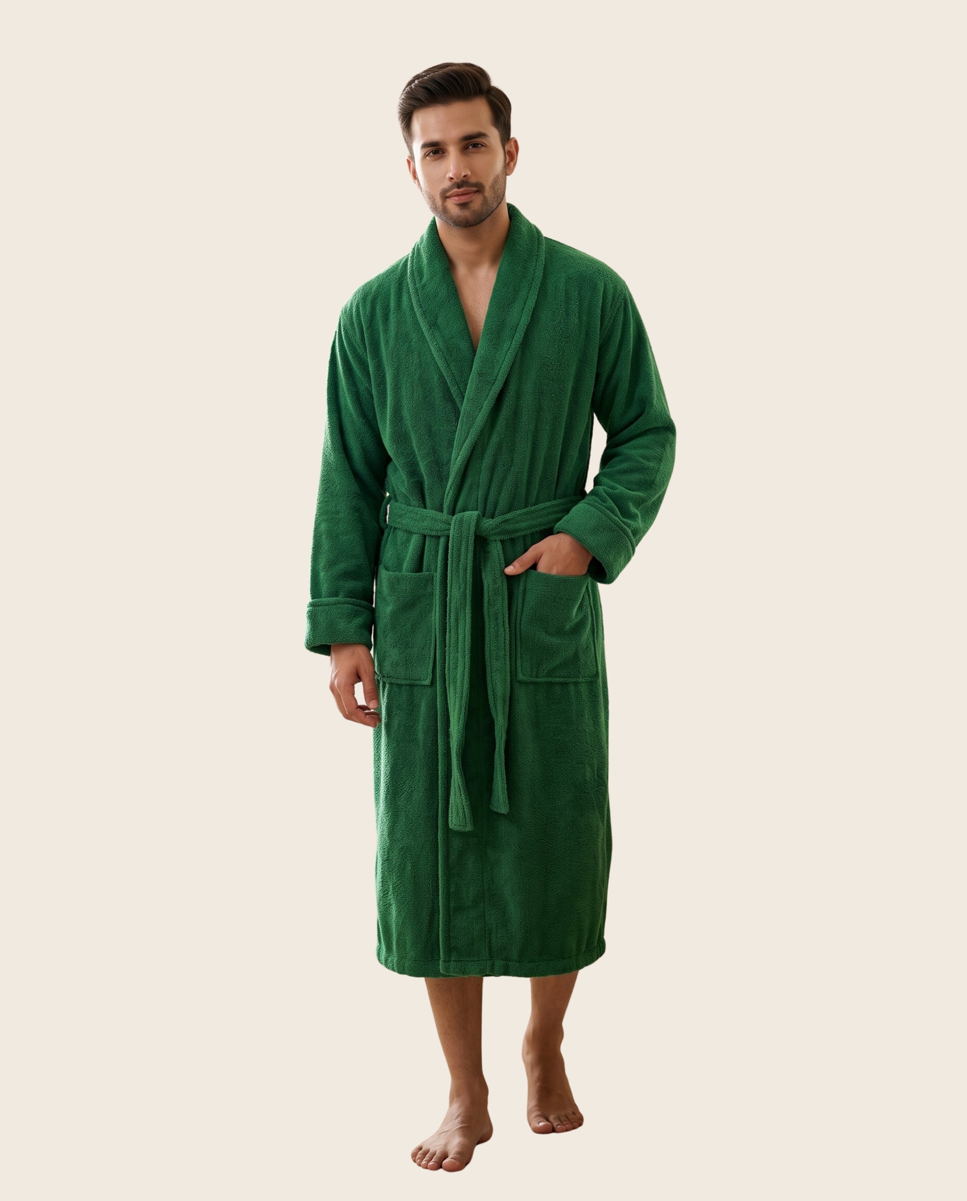 A man wearing a plush green bathrobe, standing against a solid light beige background.